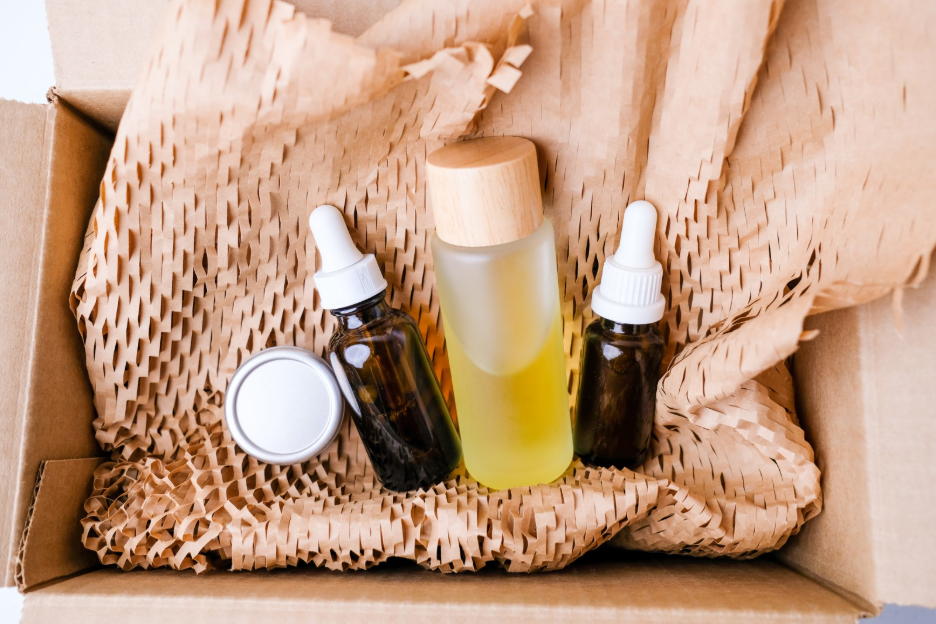 skincare bottles on top of corrugated kraft paper inside of a packaging box